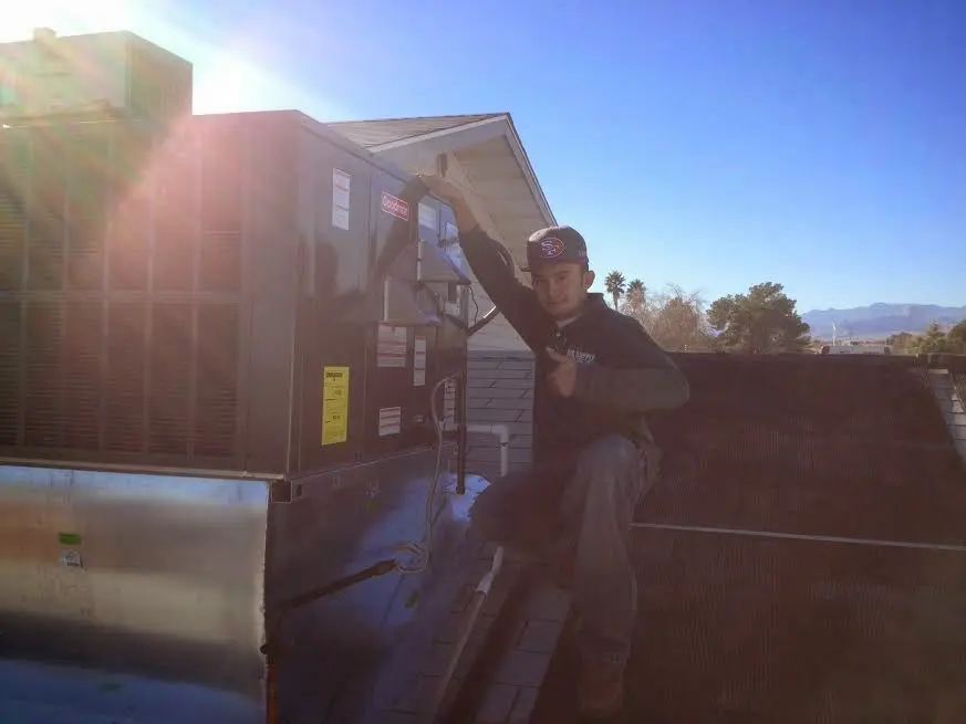 HVAC technician performing Air Duct Cleaning on a rooftop unit in Cedarburg